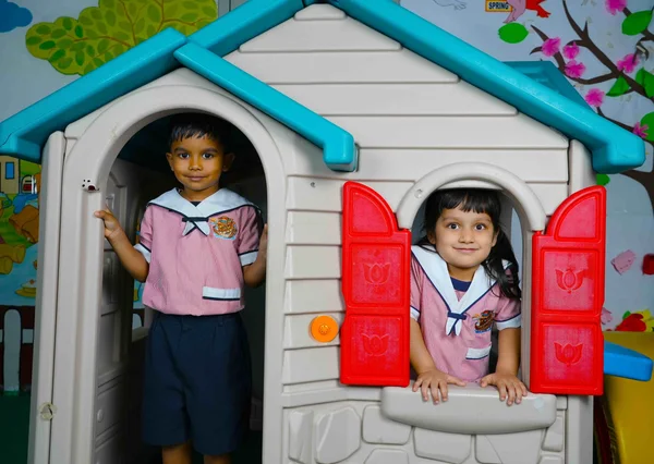 Children playing in an outdoor playhouse at Noah’s Ark Nursery