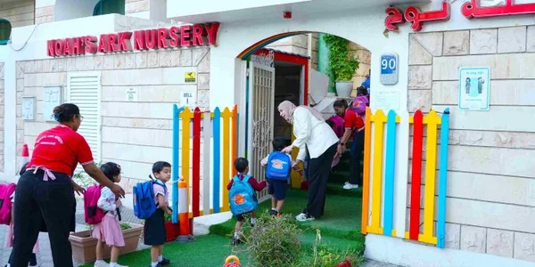 Children entering Noah’s Ark Nursery with staff support